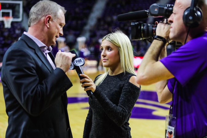 sports broadcast student interviewing basketball coach on the court