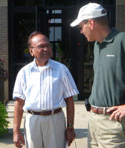 Bill Schapaugh, right, agronomy interim department head and soybean breeder, discusses soybean production with Prakash Artelli, USDA scientist specializing in resistance to soybean cyst nematode. Photo courtesy of American Soybean Association.