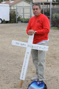 Enrique Morones, founder of the nonprofit organization Border Angels, with a cross from a migrant workers march reading, "Not One Death More."