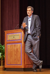 David Pogue, keynote speaker, casually leaning on the podium at Union Forum Hall