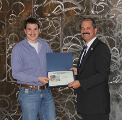 Ryan Roberts receiving his award for GSI Dept Head, Dirk Maier