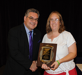 Frannie Miller receives award from Dean John Floros.