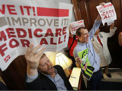 Jon Schaffer and Phil Garrity, two health activists trained by Paul Davis, protest the repeal of the Affordable Care Act in front of Senate offices in Washington, D.C.
