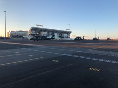 Four UH-60 Black Hawks in front of Bill Snyder Family Stadium