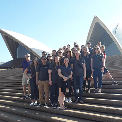 The group poses in front of the Sydney Opera House