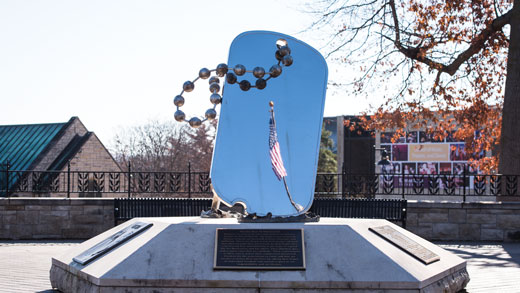 A U.S. flag is reflected in the WWII memorial