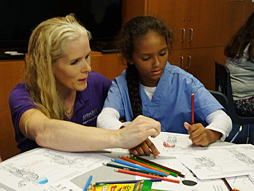 Dr. Kate KuKanich leads a student through an exercise on anatomy at the Boys & Girls Club of Manhattan