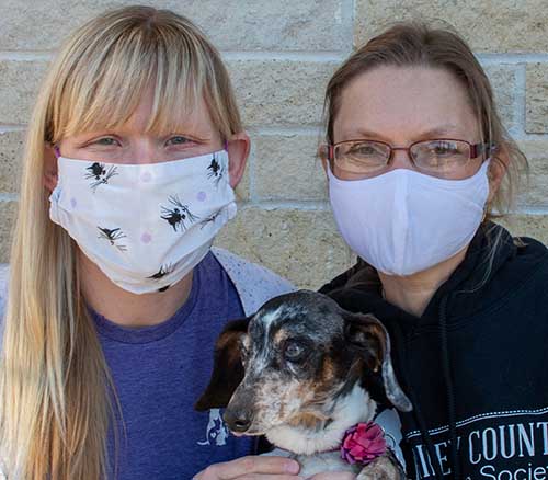 Drs. Jessica Meekins and Lisa Pohlman with foster dog Poppy