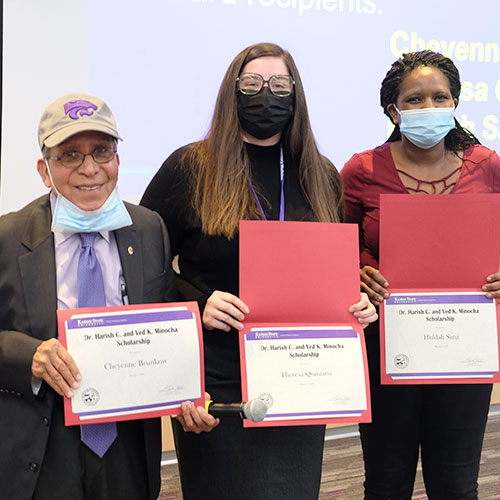 Dr. Harish Minocha presents scholarships to Theresa Quintan and Hulda Sang.