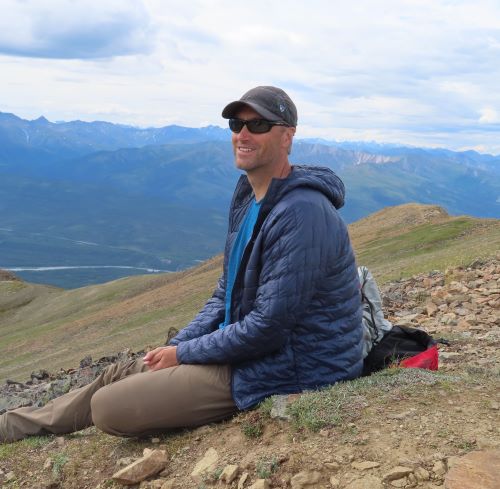 Photo of award recipient, Matt Brueseke, in the field in Alaska