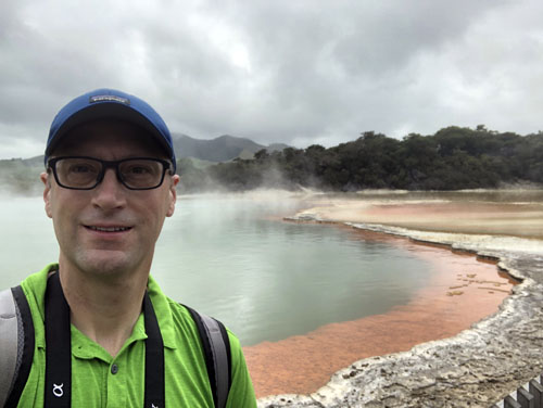 Professor Matt Brueseke in front of Champagne Pool, a gold-rich hot spring in New Zealand