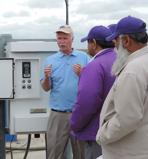 Freddie Lamm, left, explains the technical advancements in irrigation to a group of visitors from Pakistan during a previous visit to western Kansas.