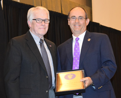 Ronnie Elmore, associate dean for academic programs, admissions and diversity programs at the Kansas State University College of Veterinary Medicine, left, congratulates Steve Stockham for receiving the 2016 Norden-Pfizer-Zoetis Animal Health Distinguished Veterinary Teacher Award
