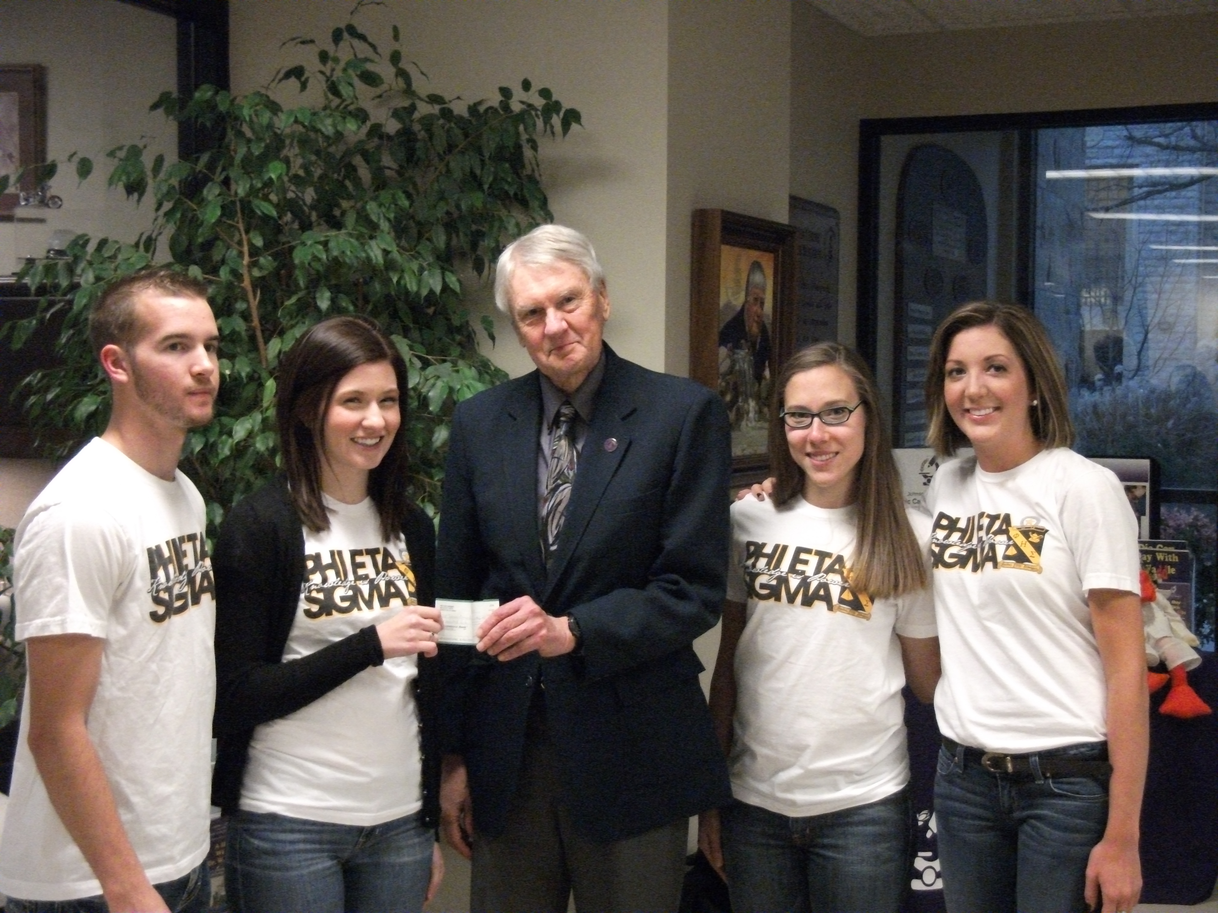 Photo of Phi Eta Sigma Officers Presenting Check