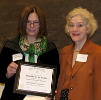 Lynn Ewanow accepts placque for Timothy deNoble and Mary Beth Kirkham