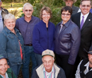 President Schulz and First Lady Noel Schulz pose with members of the Kansas Christmas Tree Grower's Association, which provided the tree for the President's residence.
