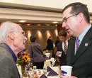 President Schulz visits with a K-State supporter at a grain science event.