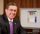 A portrait of President Kirk Schulz at his desk.