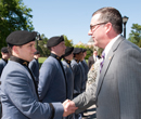 President Schulz congratulates a member of the Pershing Rifles, also known as Company G-7.