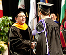 President Schulz congratulates a graduate at the College of Business Administration commencement.
