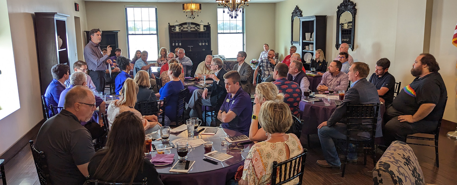 This image shows a group of people participating in a K-State 105 session in Hoxie.