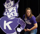 Guests pose with K-State marks from years past.