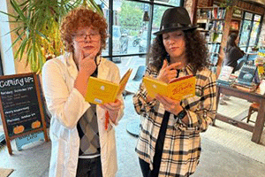 Two K-State students read clues during a mystery role play activity in a CAT Community.