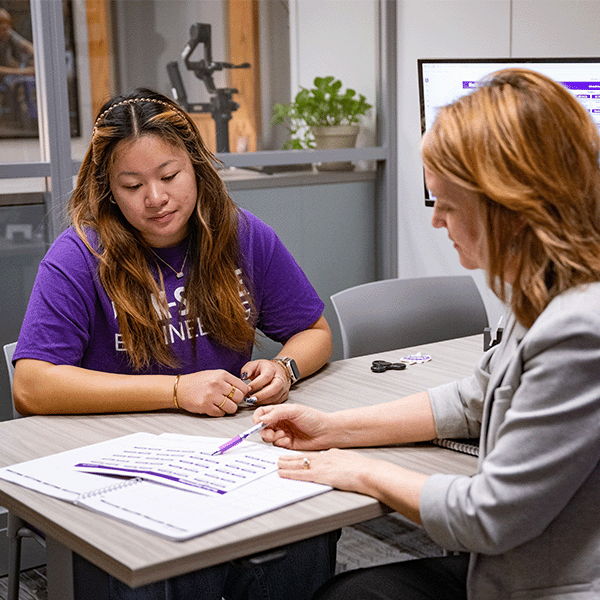 A K-State student meets with her academic advisor, a key player in students' academic support package.