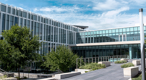 The College of Architecture, Planning and Design's atrium and courtyard on a sunny day.