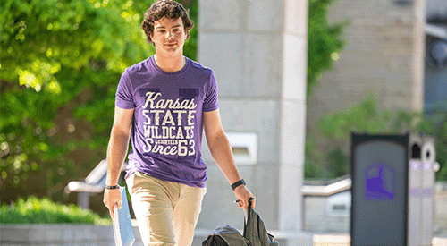 A student crosses Bosco Plaza, his backpack in hand.