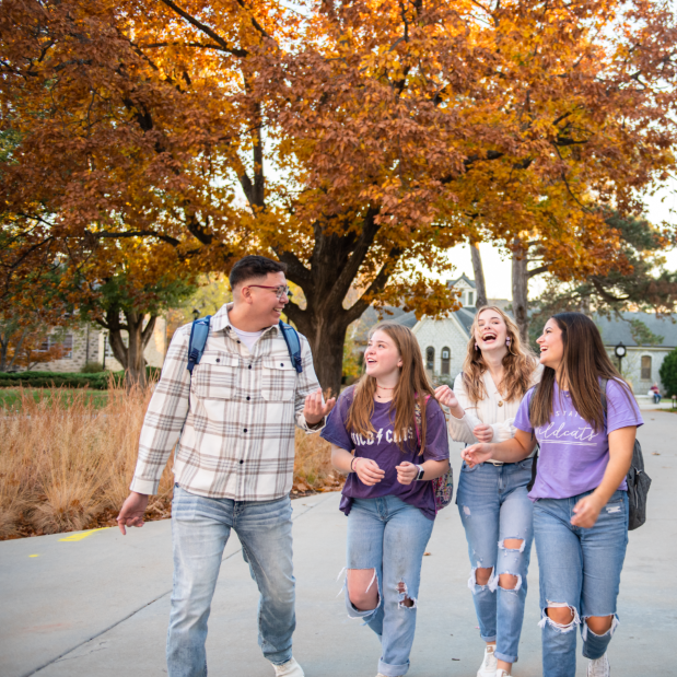 Students walking on campus, laughing