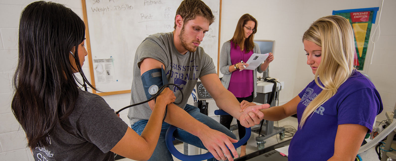 Students measuring blood pressure of another student