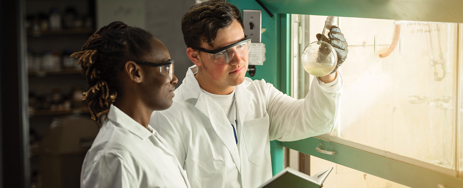 Two student scientists conducting an experiment.