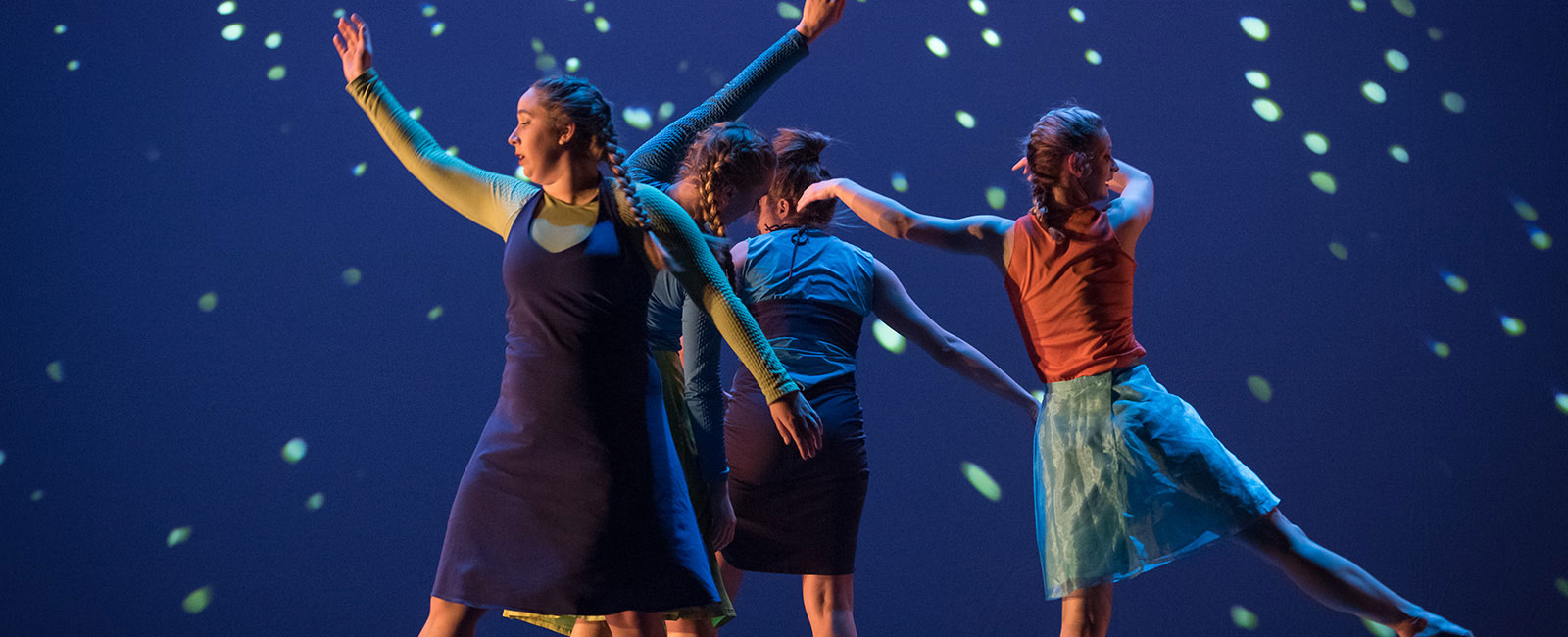 Four dancers in a performance.