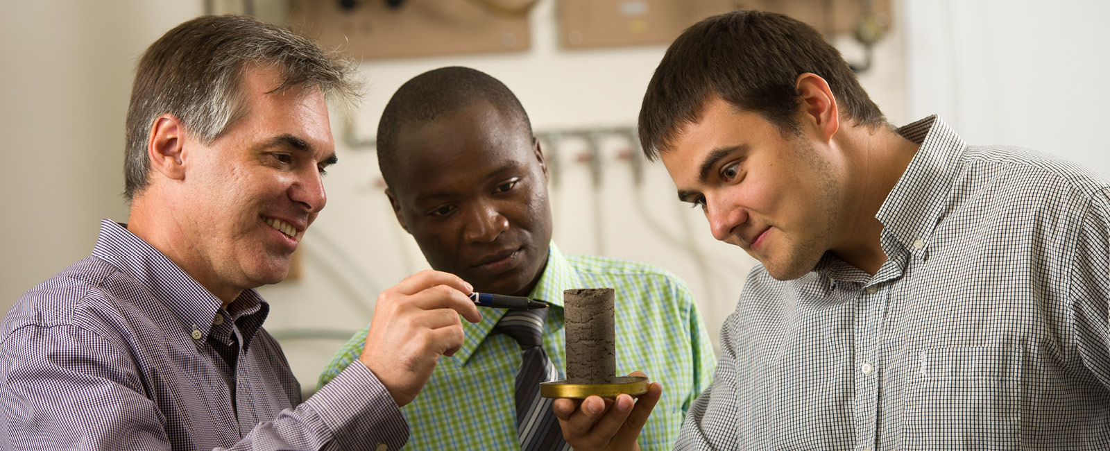 Students and professor working in lab