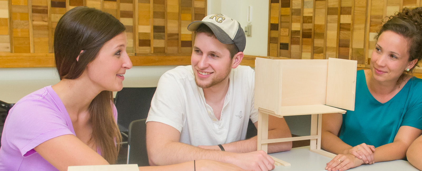 Architecture students working with design model