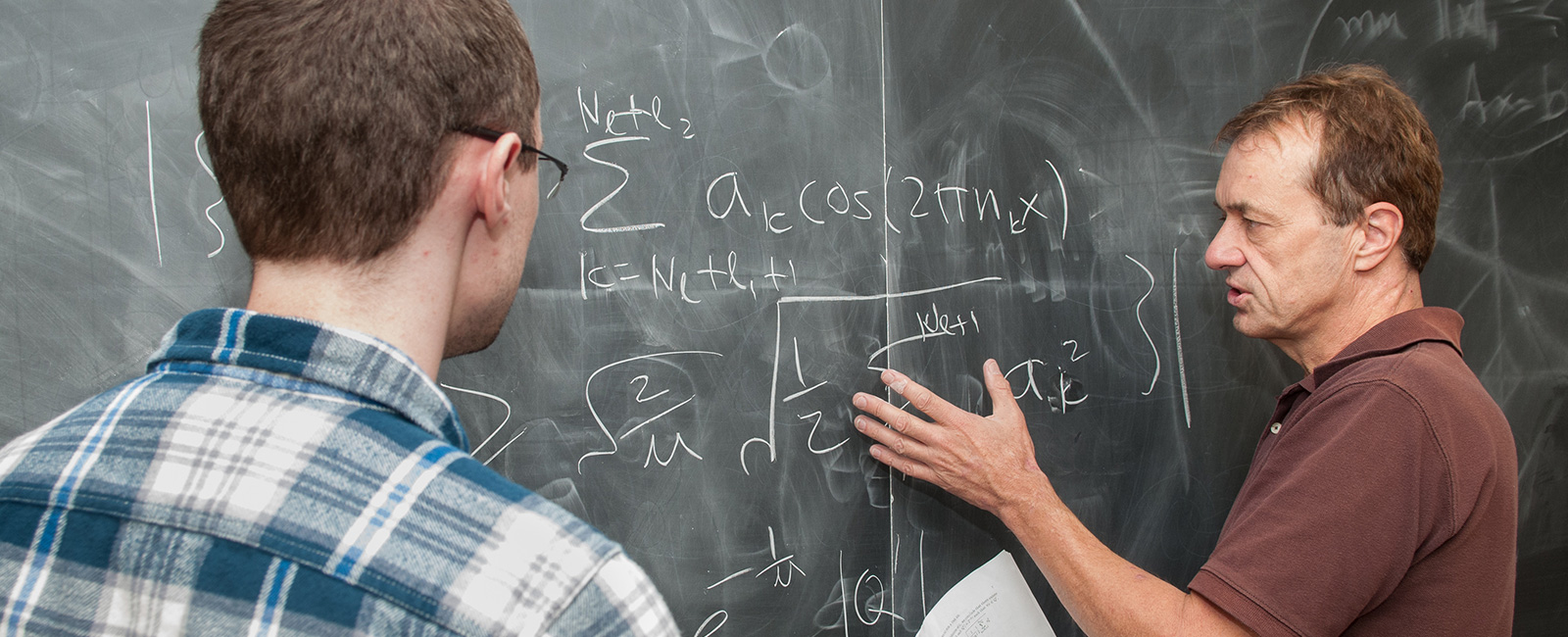 Student and professor working on math equation 