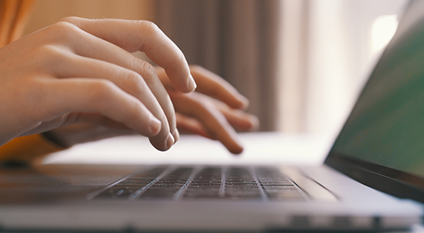A student filling out a form on a keyboard.