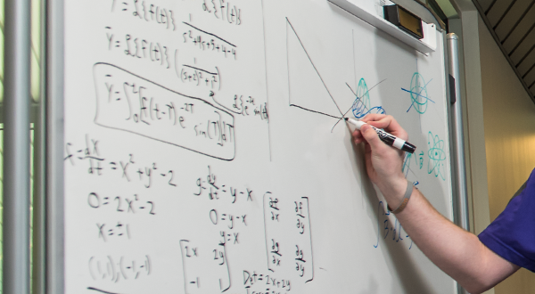 An instructor drawing a graph on a whiteboard.