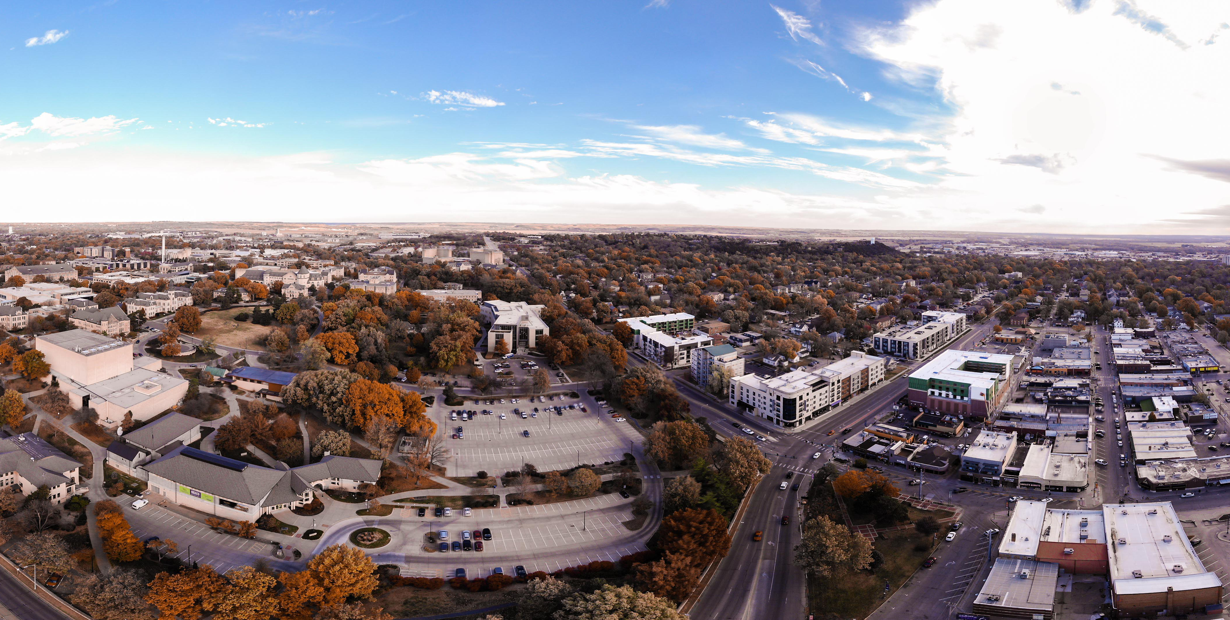 a student in a K-State sweatshirt holding a notebook on the steps of Chalmers