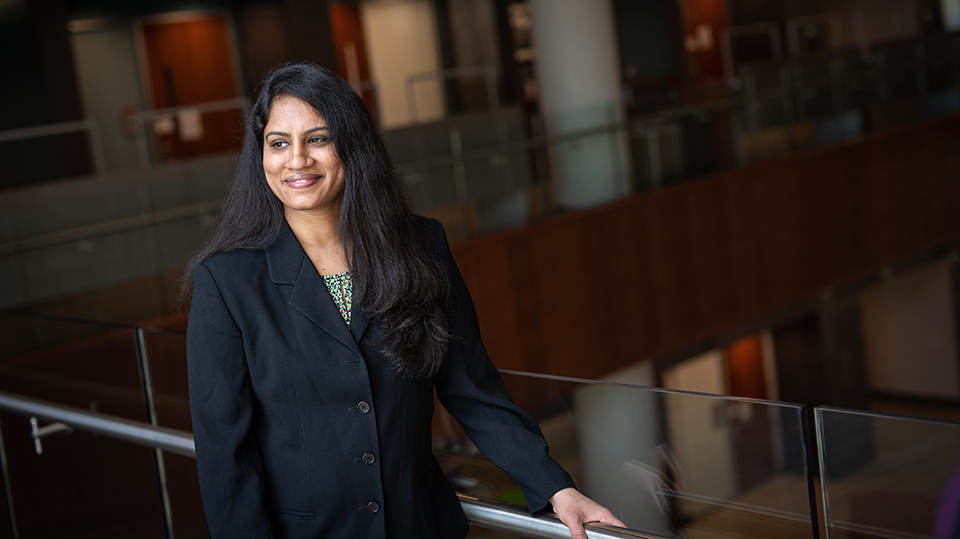 woman leaning against railing in business building