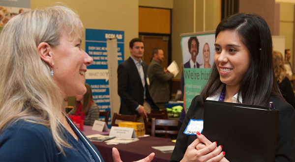 Graduate student talking with a professional