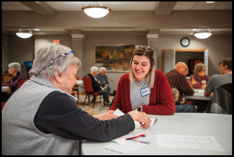 Holli, a gerontology student, is sitting with a resident at the local retirement community.