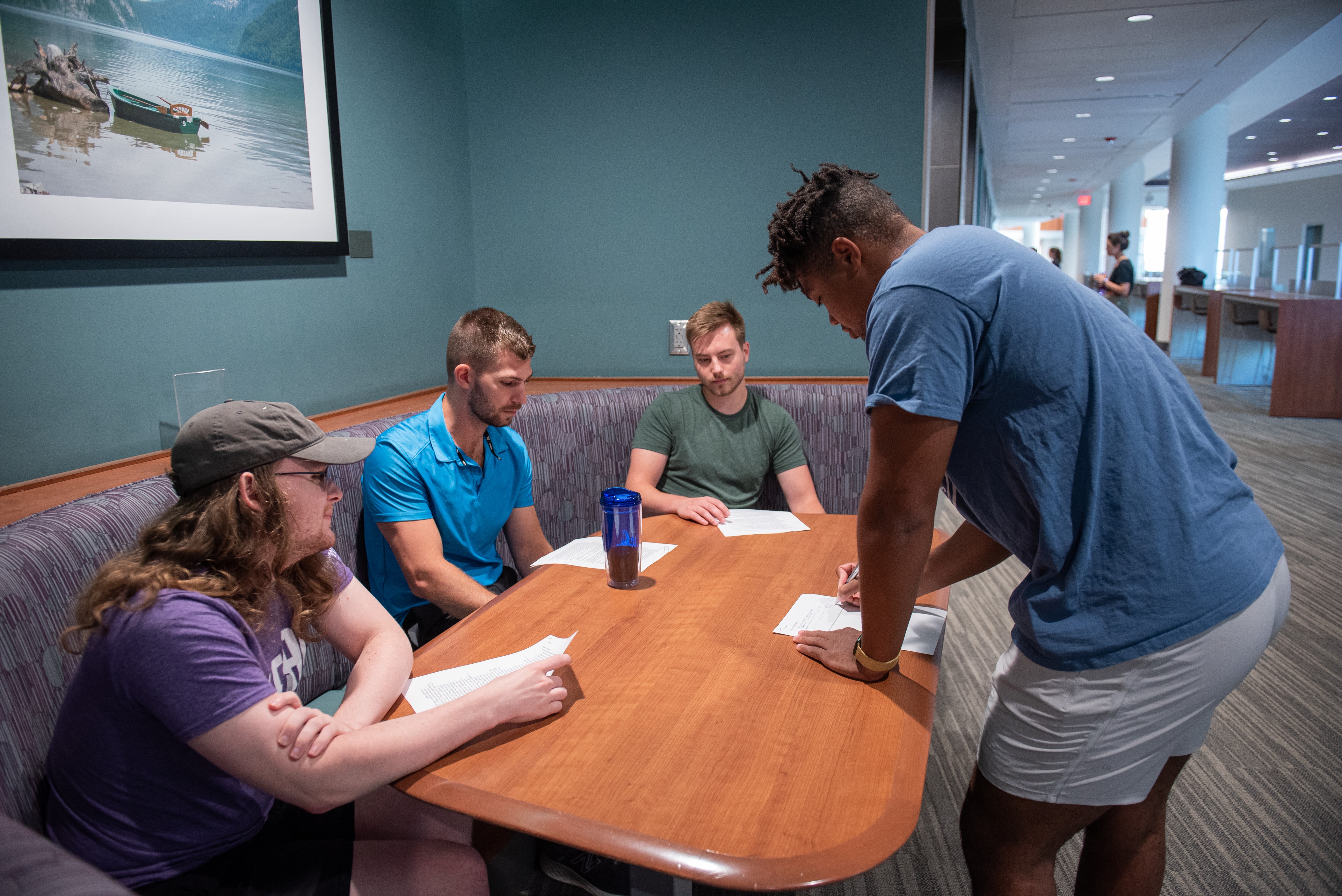 A photo of four MIOP students working together during an on-campus summer course. 