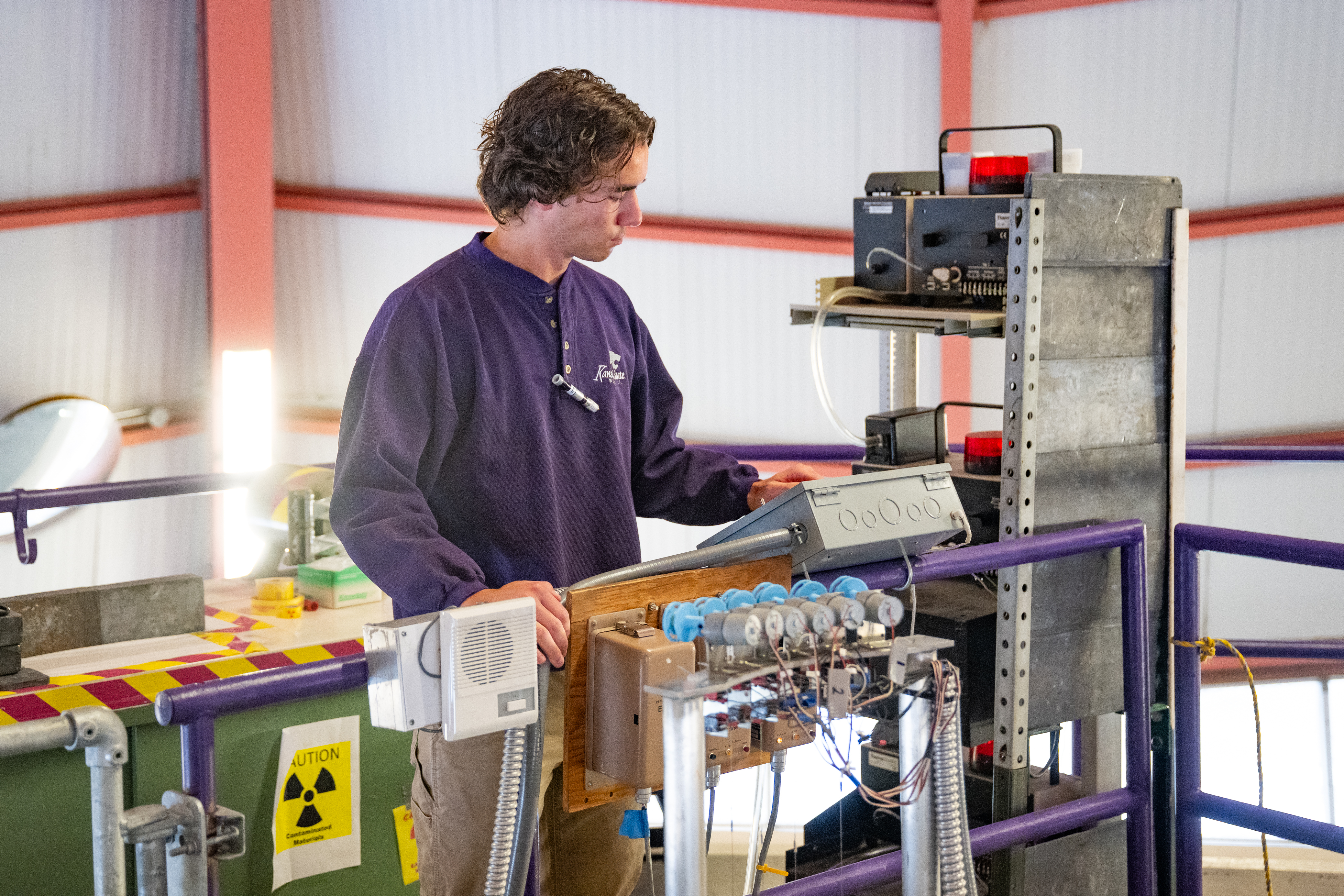 student in front of reactor