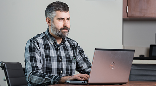 Student working online with a laptop computer