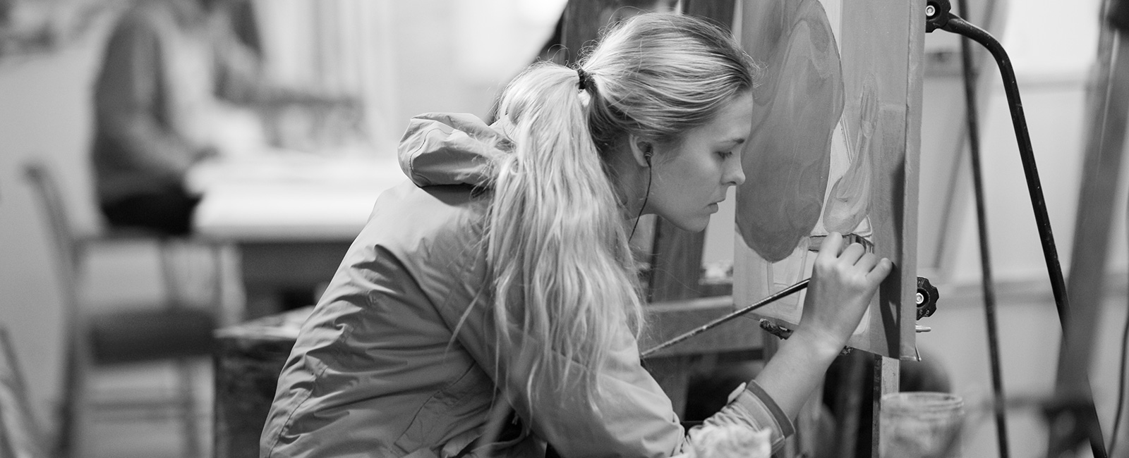 Student painting in studio