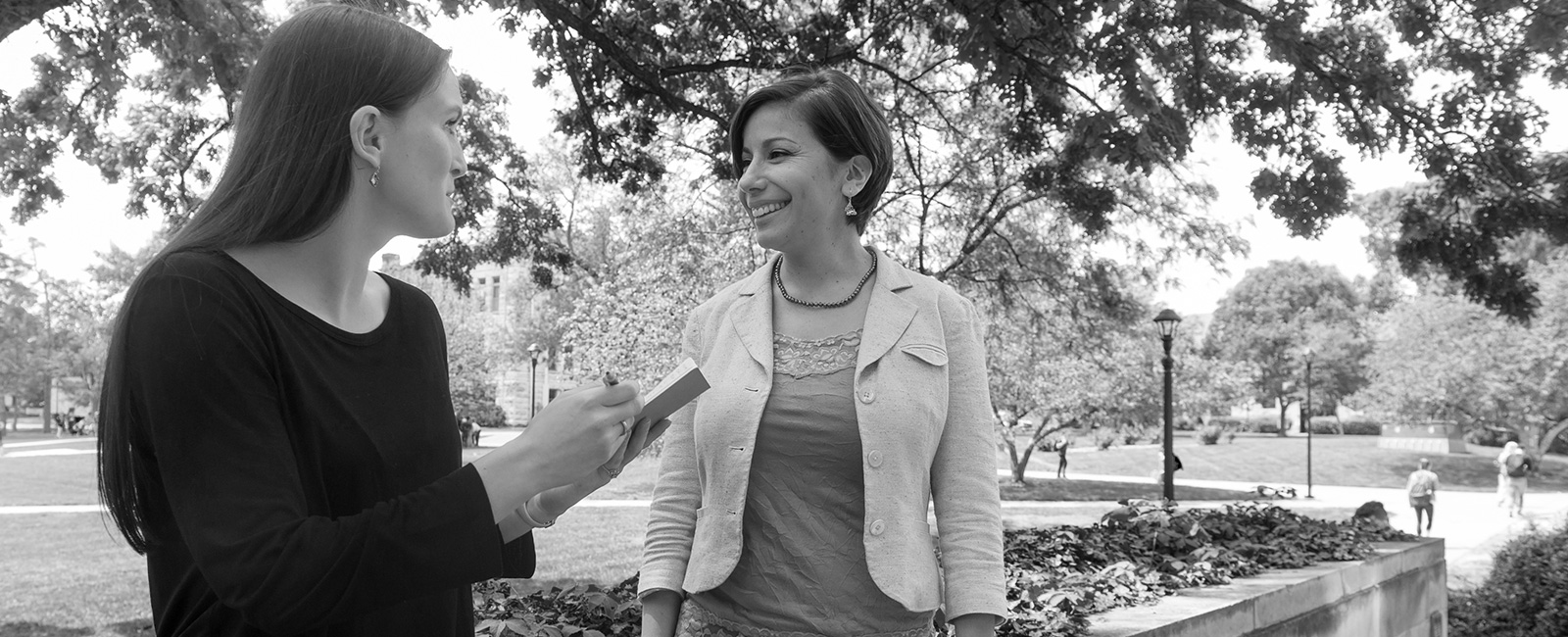 Two people talking on campus