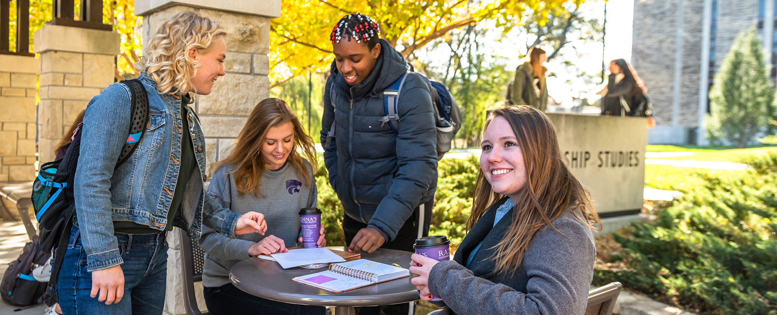 Student working together on a sunny day on the Manhattan campus