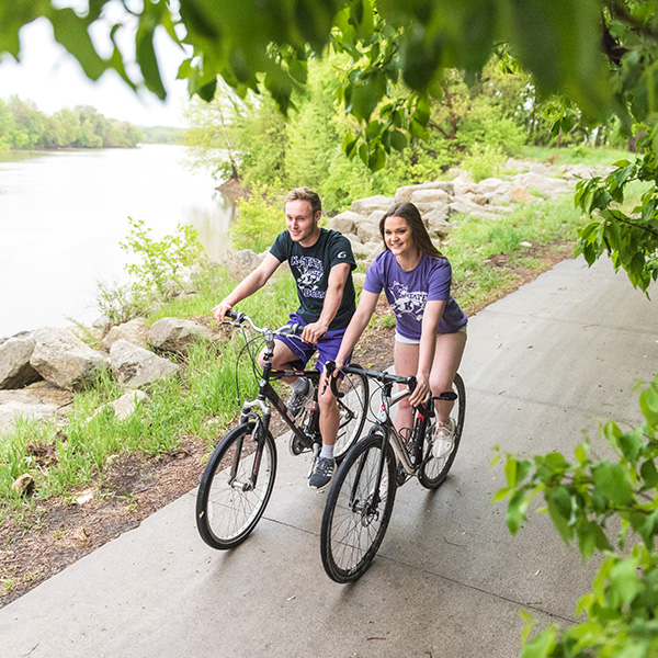 Students riding bicycles on Manhattan trails